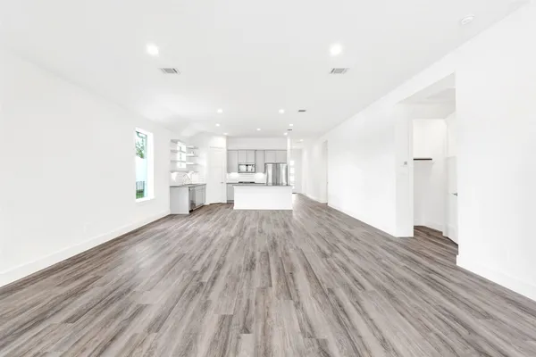 a kitchen with wooden floor and window