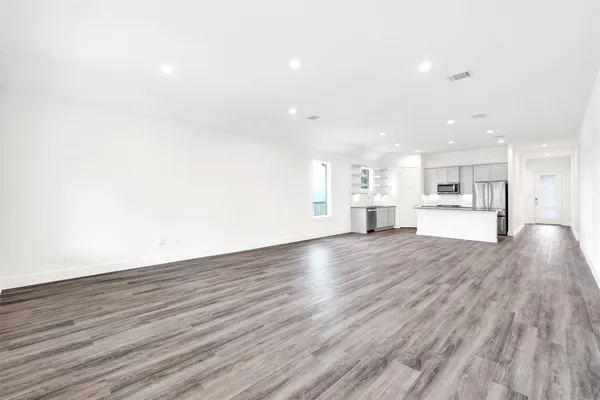 a view of a living room with wooden floor