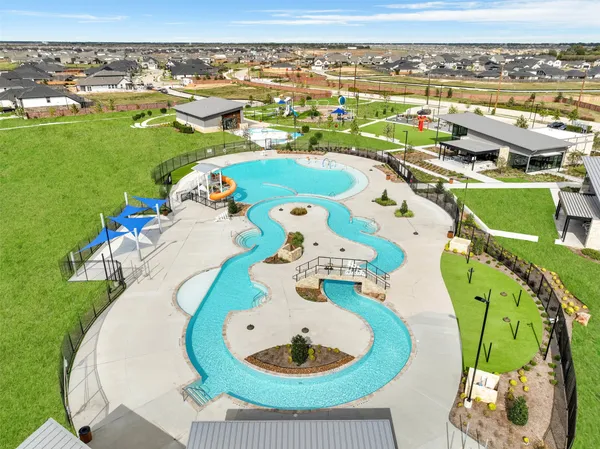 an aerial view of a swimming pool with a yard