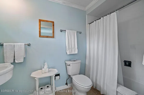 a white toilet sitting next to a bathroom sink