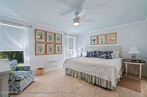 a bedroom with a bed and ceiling fan