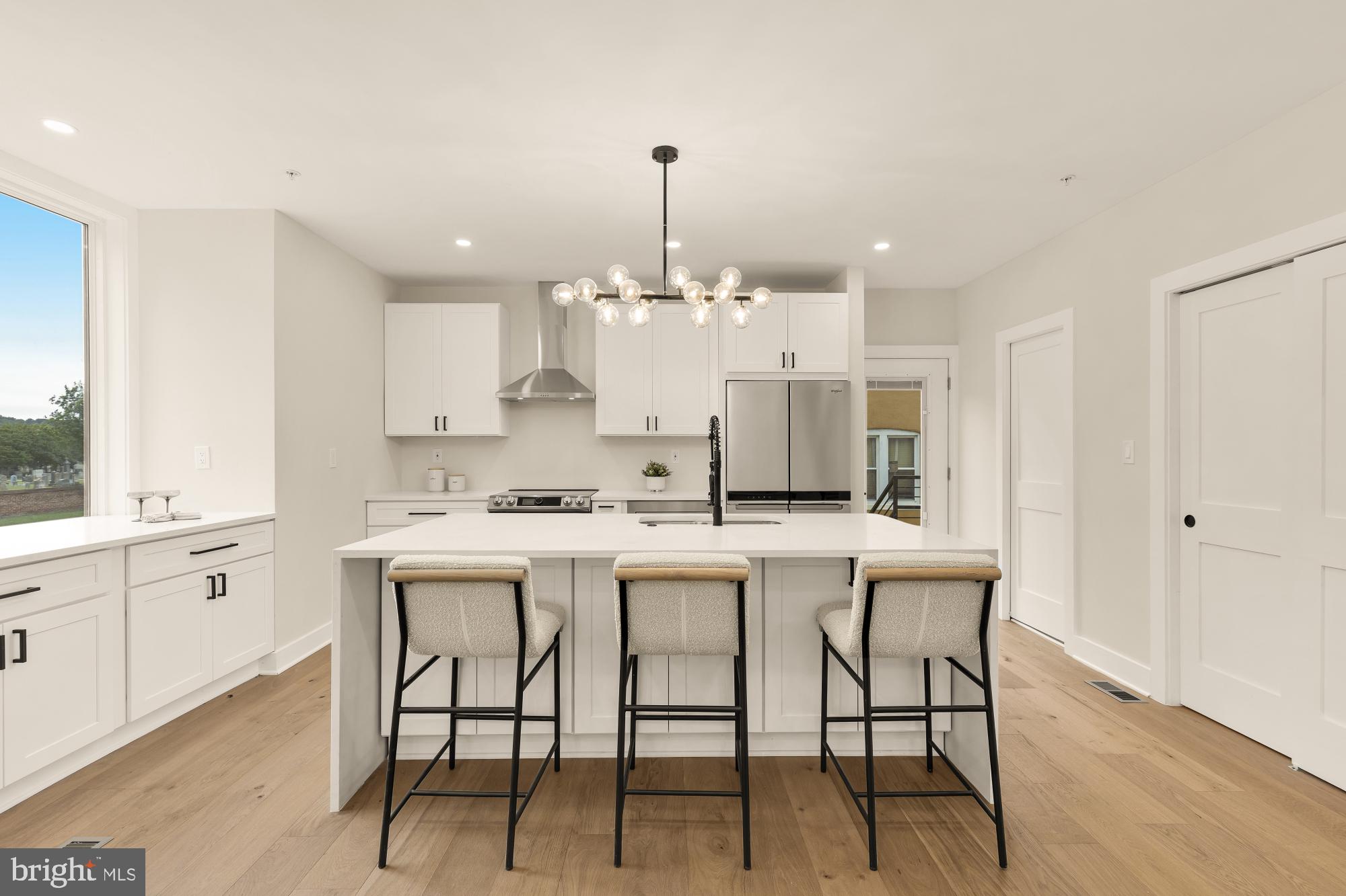 1631 G Street Southeast Washington, DC 20003 - Photo 11 of 42 a kitchen with kitchen island a dining table chairs sink and cabinets