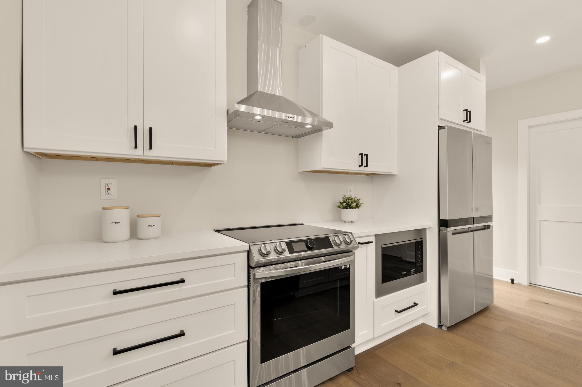 1631 G Street Southeast Washington, DC 20003 - Photo 14 of 42 a kitchen with stainless steel appliances granite countertop a stove a sink and a microwave