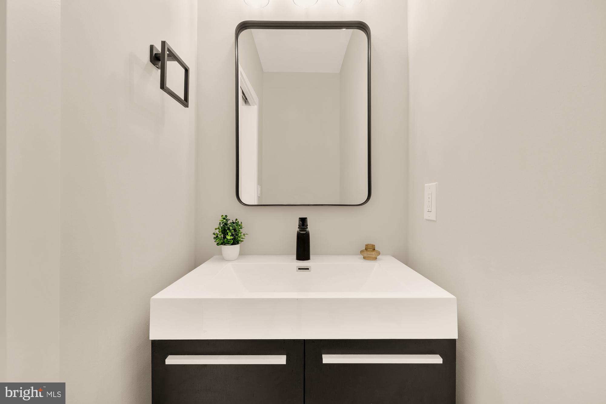 1631 G Street Southeast Washington, DC 20003 - Photo 17 of 42 a bathroom with a sink and a mirror