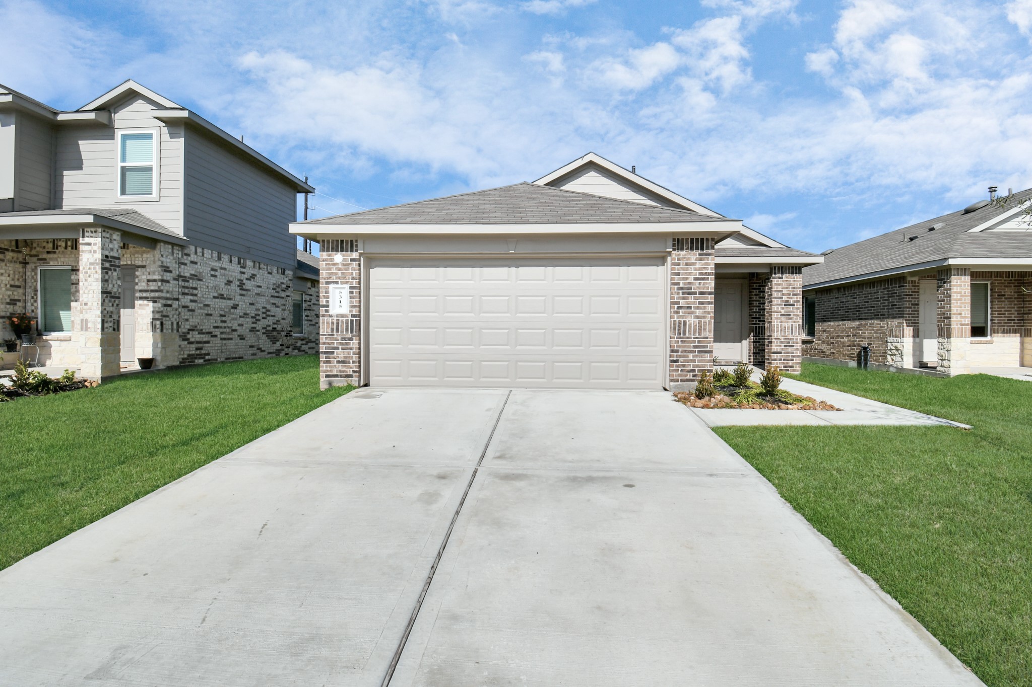 5315 Castlebury Meadows Dr Spring Spring, TX 77373 - Photo 4 of 39 a front view of a house with a yard and garage