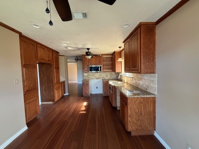 4503 Rattan Avenue Bay City, TX 77414 - Photo 2 of 8 a kitchen with stainless steel appliances granite countertop a refrigerator a sink dishwasher a stove and white countertops with wooden floor