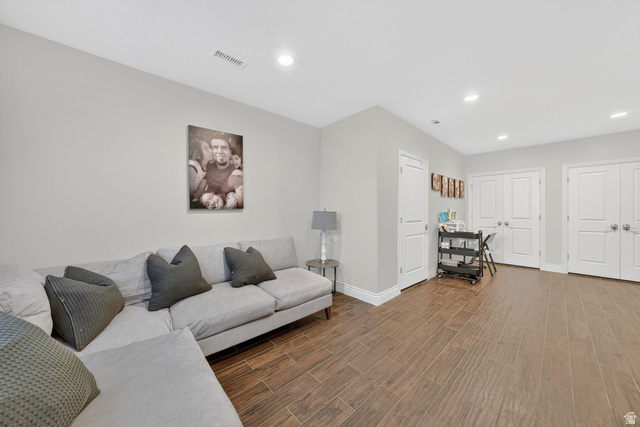 14738 Tangle Hill Road Herriman, UT 84096 - Photo 47 of 66 Spacious room featuring wood-finish flooring and light gray walls