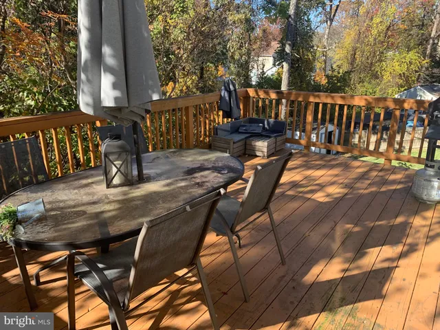 a view of balcony with wooden floor and outdoor seating