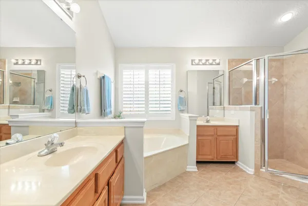 a bathroom with a tub sink and mirror