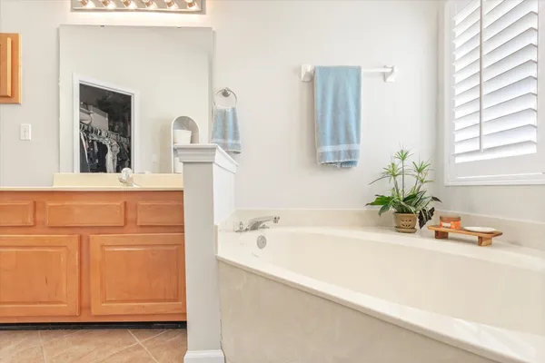 a bathroom with a granite countertop shower and a sink