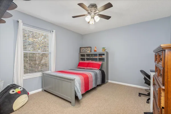 a living room with furniture a flat screen tv and wooden floor