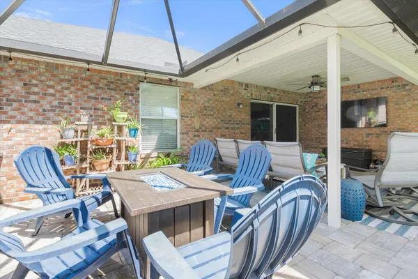 a view of a patio with table and chairs and potted plants