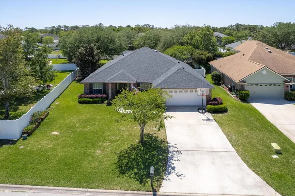 an aerial view of a house with a swimming pool yard and outdoor seating