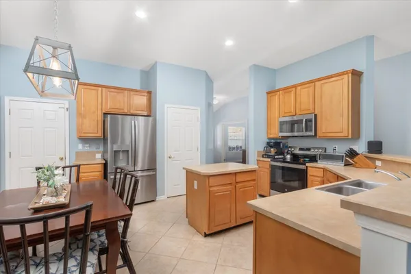 a kitchen that has a table and chairs in it