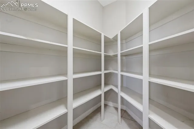 a view of walk in closet with empty racks