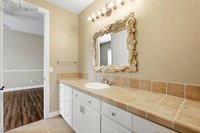 a bathroom with a double vanity sink and a mirror
