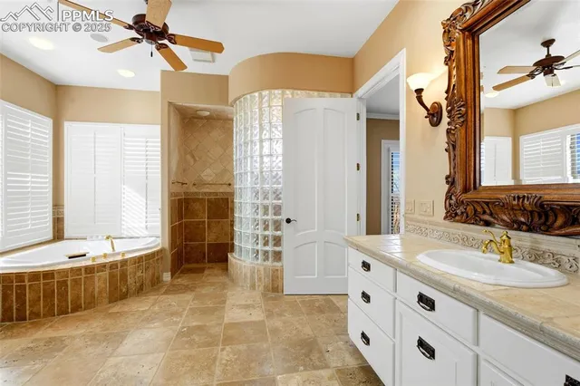 a spacious bathroom with a tub sink and mirror