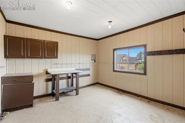 a view of cabinets with stainless steel appliances wooden floor and chair