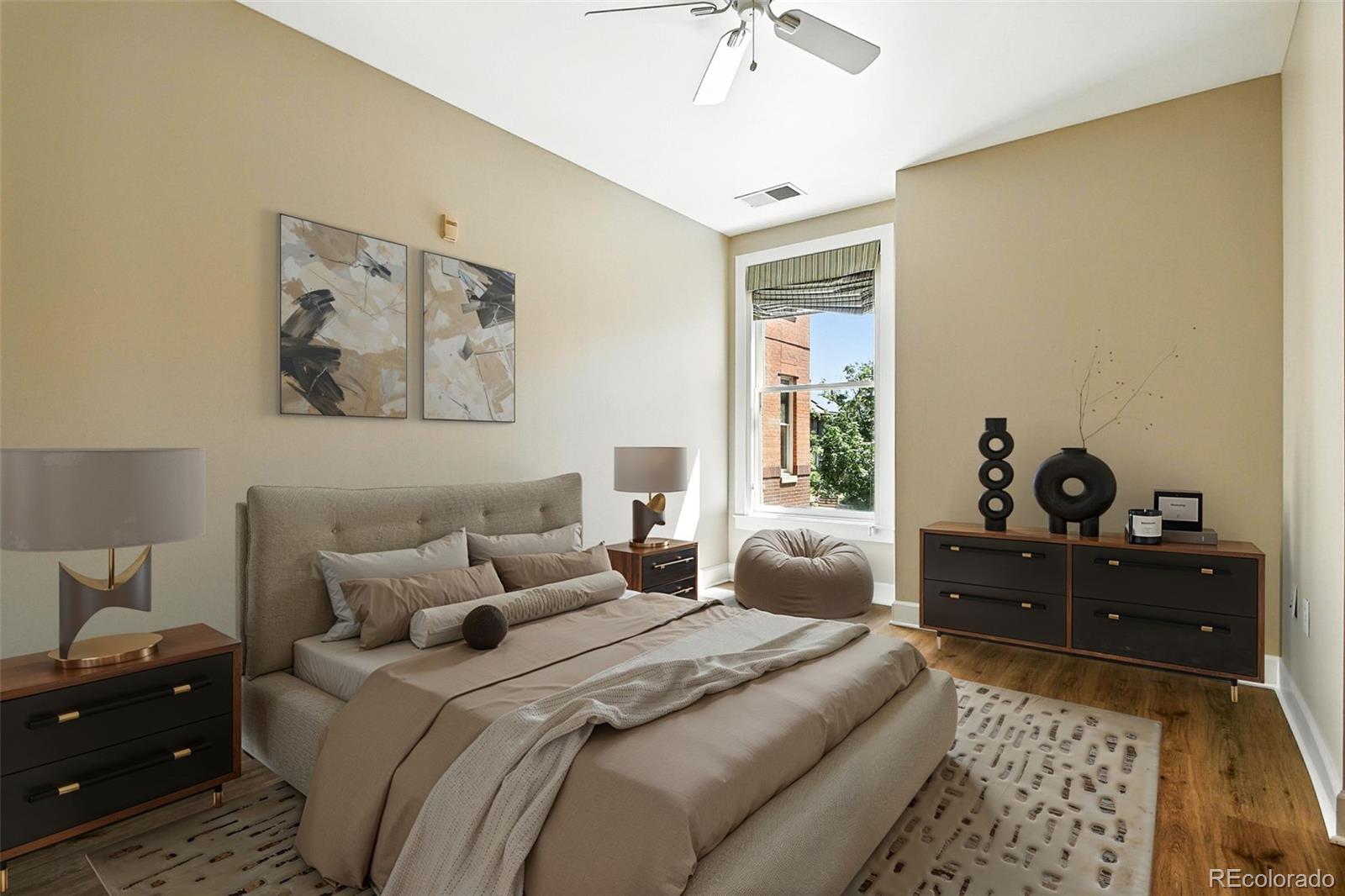 1631 Emerson Street, Unit 207 Denver, CO 80218 - Photo 14 of 30 a bedroom with a bed and wooden floor