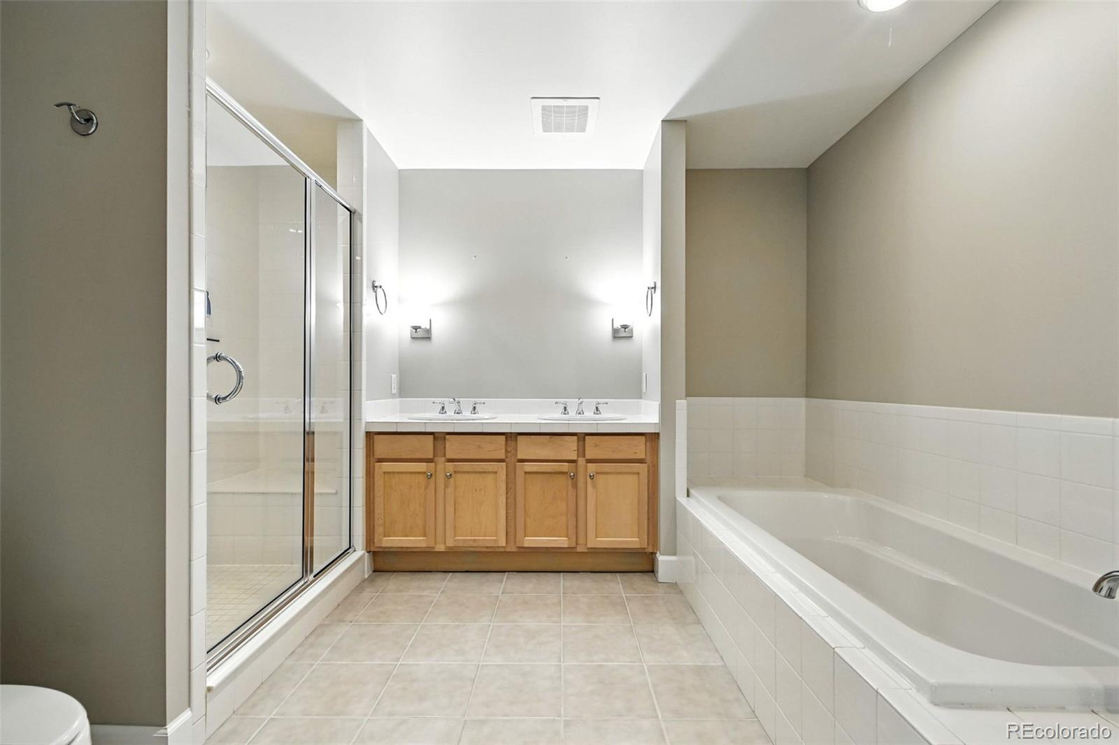 1631 Emerson Street, Unit 207 Denver, CO 80218 - Photo 15 of 30 a bathroom with a granite countertop tub sink shower and mirror