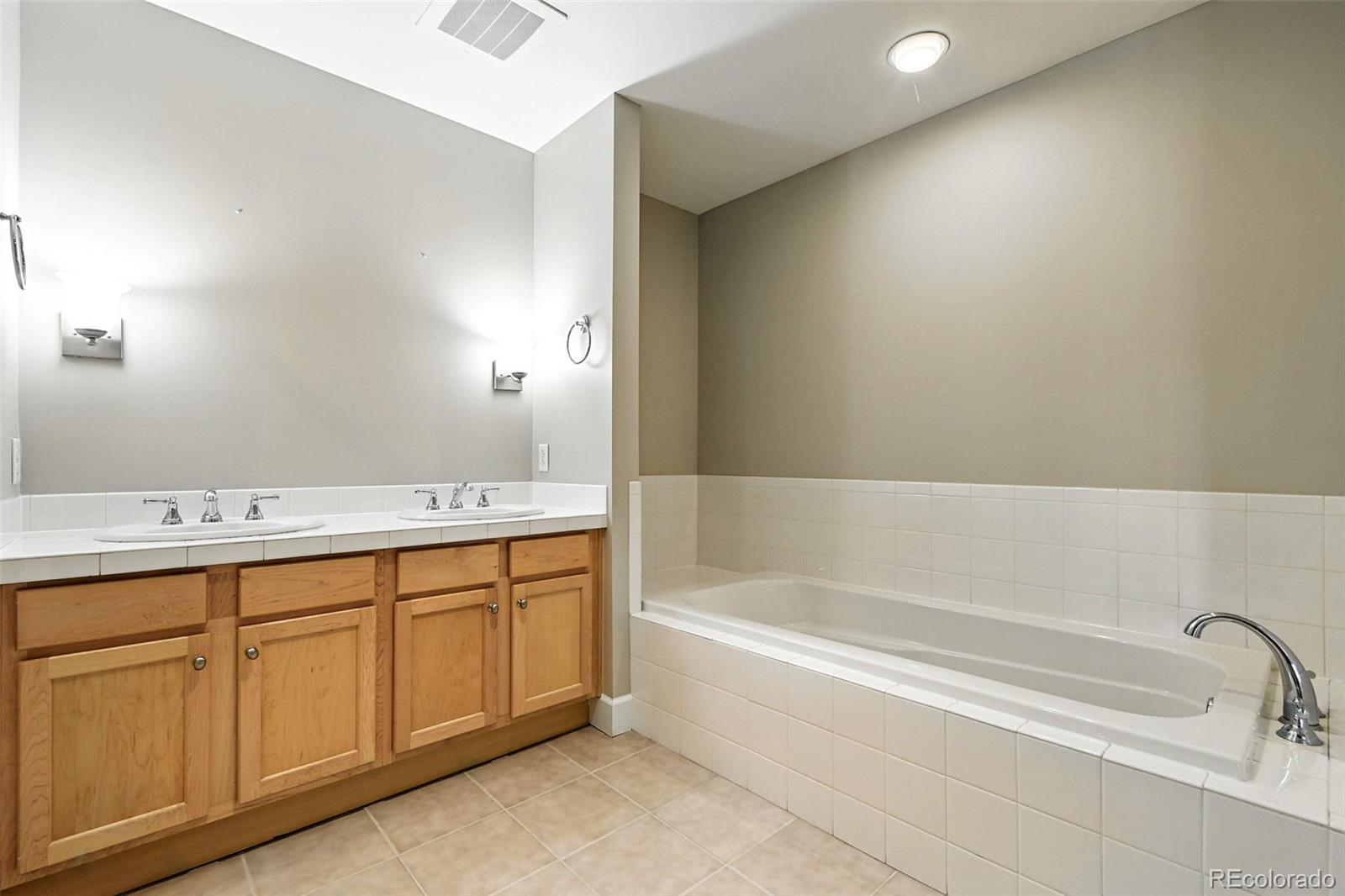 1631 Emerson Street, Unit 207 Denver, CO 80218 - Photo 17 of 31 a bathroom with a tub sink and mirror