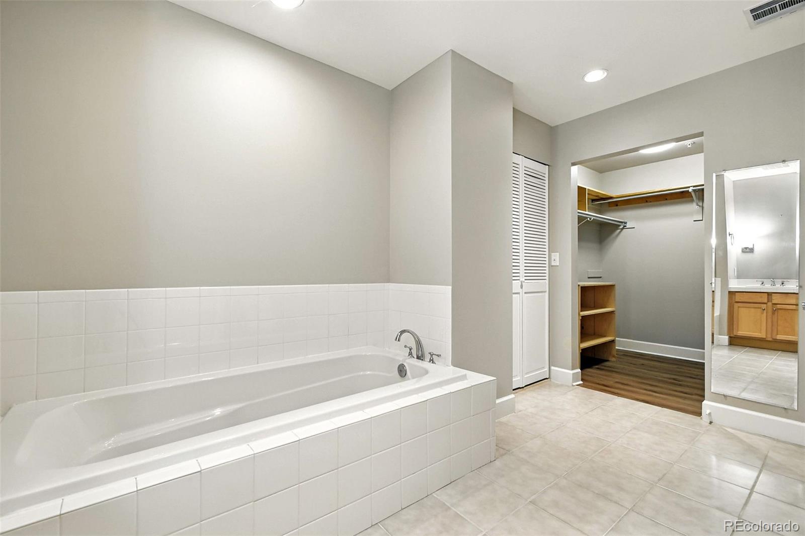 1631 Emerson Street, Unit 207 Denver, CO 80218 - Photo 17 of 30 a spacious bathroom with a bathtub and a shower
