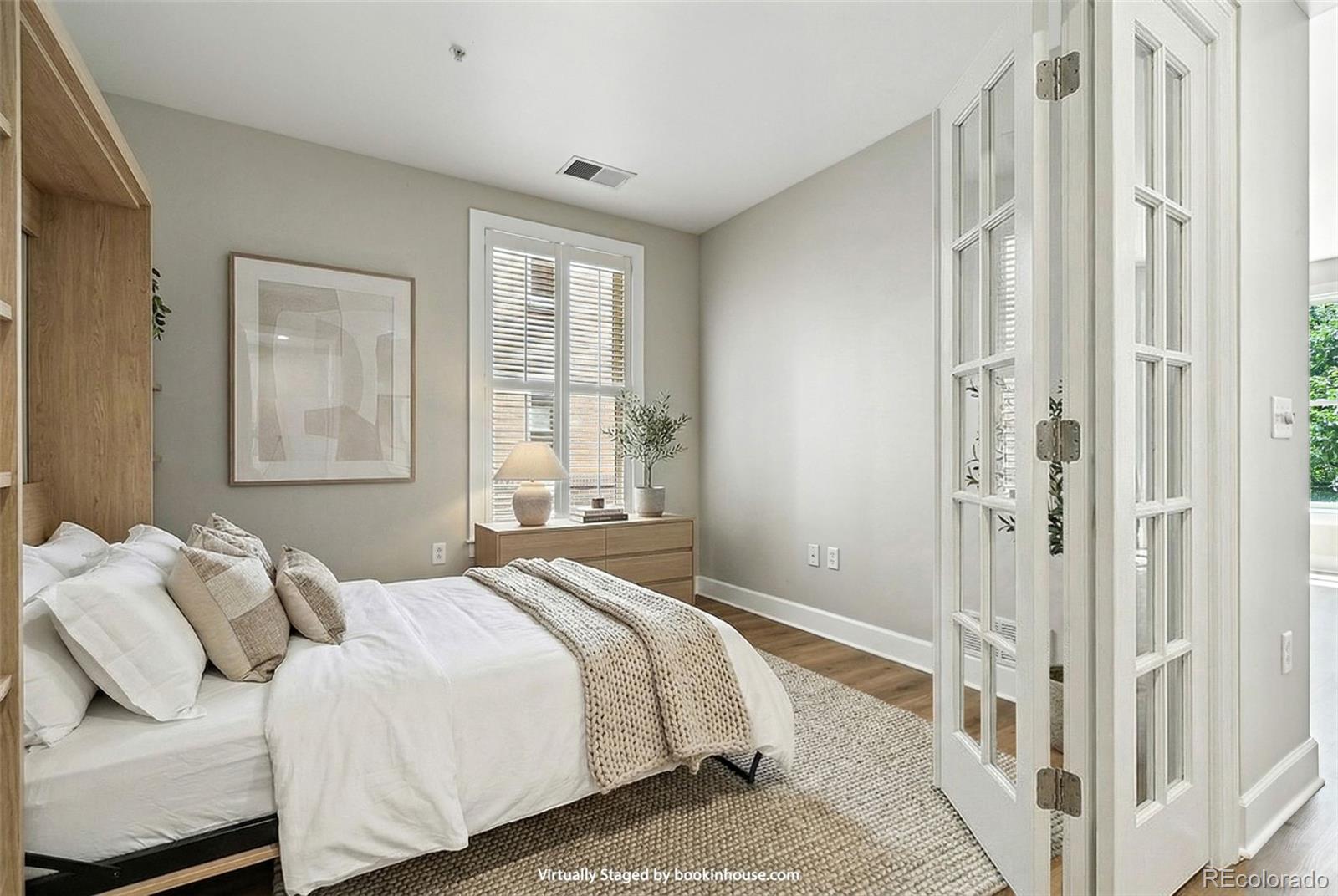 1631 Emerson Street, Unit 207 Denver, CO 80218 - Photo 20 of 32 a bedroom with a bed and a window