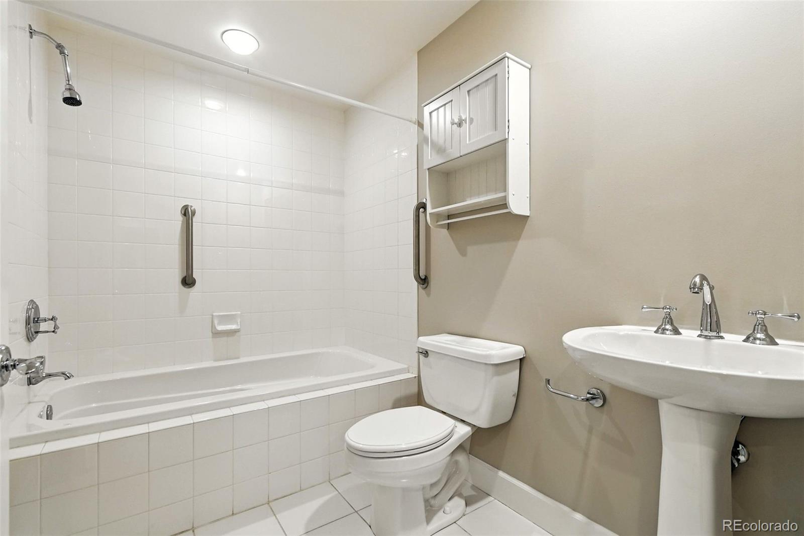 1631 Emerson Street, Unit 207 Denver, CO 80218 - Photo 21 of 30 a bathroom with a sink toilet and shower