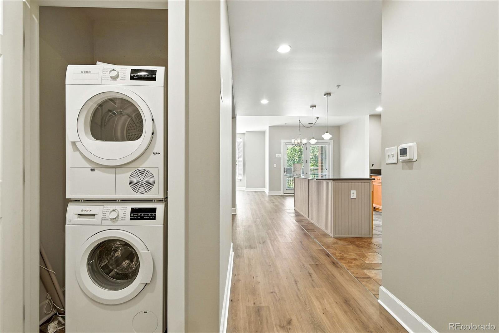 1631 Emerson Street, Unit 207 Denver, CO 80218 - Photo 26 of 32 a view of a hallway with washer and dryer