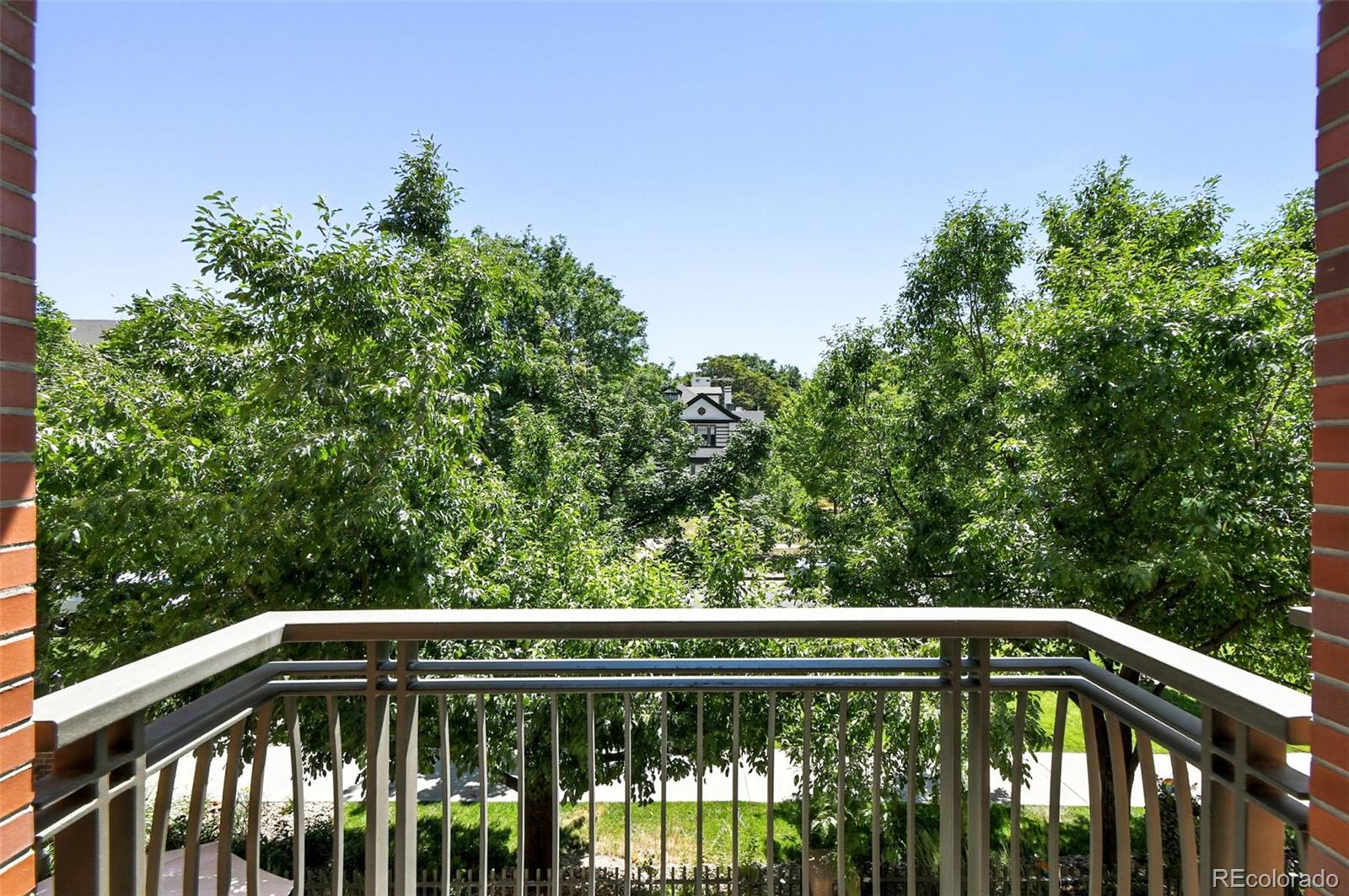 1631 Emerson Street, Unit 207 Denver, CO 80218 - Photo 28 of 32 a view of balcony with deck and trees