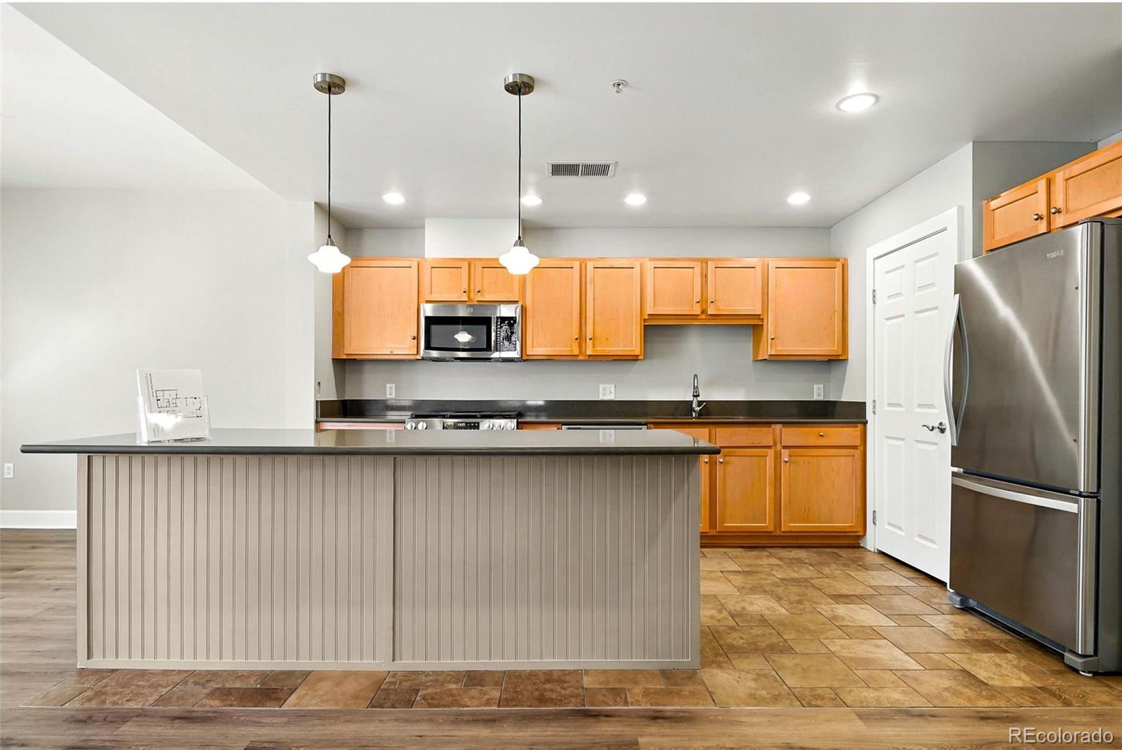 1631 Emerson Street, Unit 207 Denver, CO 80218 - Photo 8 of 30 a kitchen with stainless steel appliances granite countertop a refrigerator a sink a stove and a wooden floors