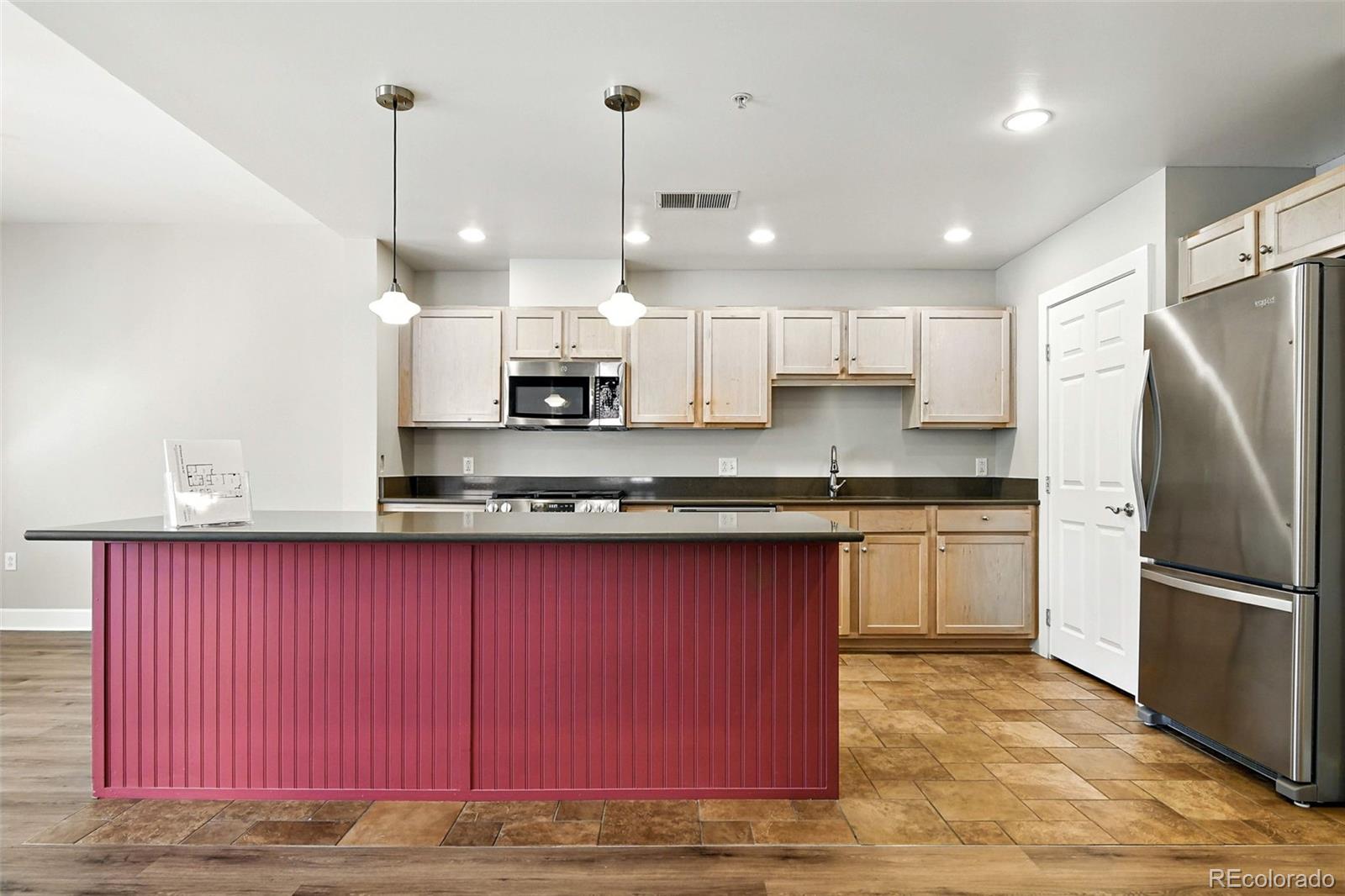 1631 Emerson Street, Unit 207 Denver, CO 80218 - Photo 8 of 31 a kitchen with stainless steel appliances granite countertop a refrigerator a sink and a stove
