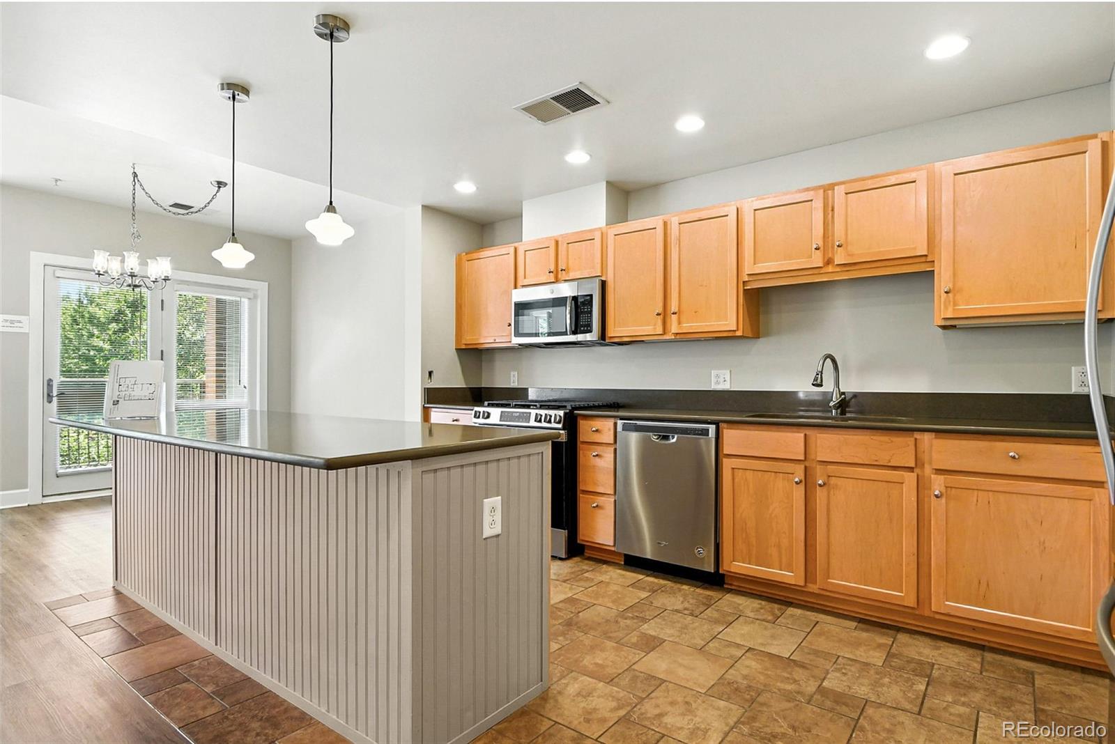 1631 Emerson Street, Unit 207 Denver, CO 80218 - Photo 9 of 30 a kitchen with stainless steel appliances granite countertop a sink a stove and a wooden floors