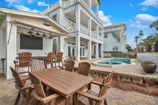 a view of a patio with table and chairs and potted plants