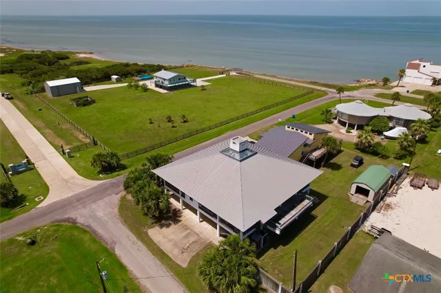 an aerial view of a pool patio kitchen and outdoor seating