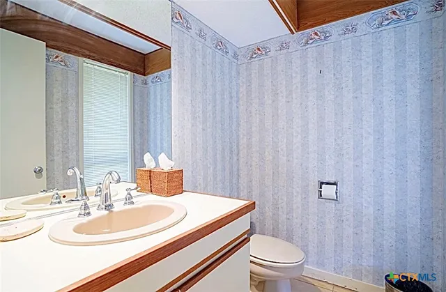 a kitchen with stainless steel appliances granite countertop a sink and a refrigerator