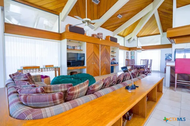a kitchen with stainless steel appliances kitchen island granite countertop a table chairs and a refrigerator