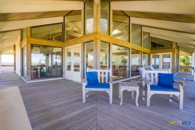 a view of a hallway to a livingroom with furniture and an entryway