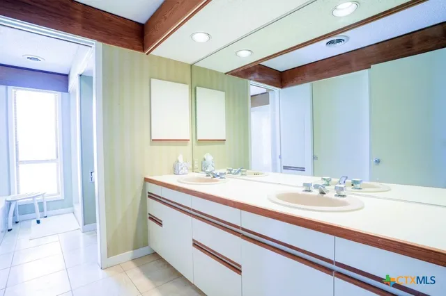 a bedroom with a bed and a chair