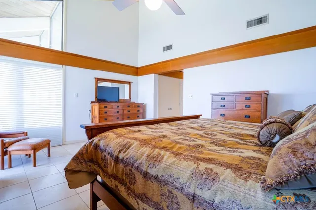 a view of a hallway with wooden cabinets