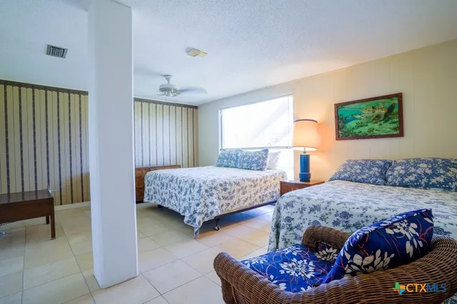 a bedroom with a bed and a chair