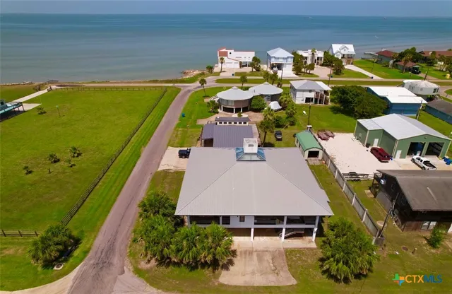 an aerial view of a house with a swimming pool