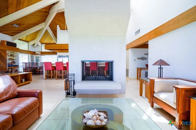 a living room with furniture a ceiling fan and a window