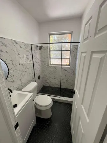 a bathroom with a sink toilet and shower