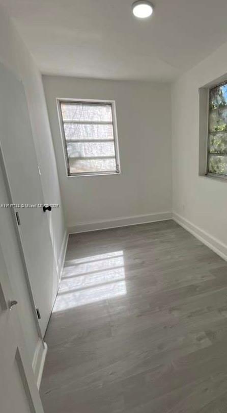 1560 Southwest 5th Street, Unit 11 Miami, FL 33135 - Photo 11 of 12 wooden floor in an empty room with a window