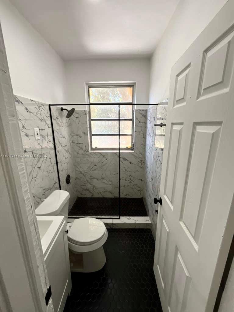 1560 Southwest 5th Street, Unit 11 Miami, FL 33135 - Photo 2 of 12 a bathroom with a toilet and a shower