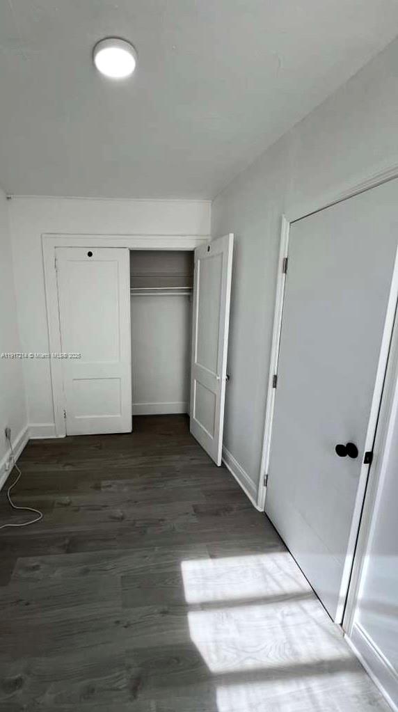 1560 Southwest 5th Street, Unit 11 Miami, FL 33135 - Photo 5 of 12 an empty room with wooden floor and entrance