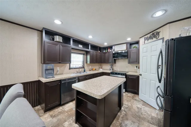 a kitchen with a sink stove and refrigerator