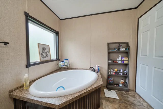 a bathroom with a tub and shower