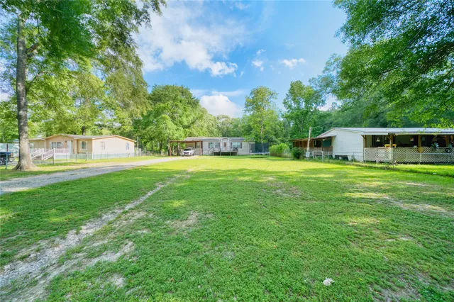 a view of a house with a yard deck and sitting area